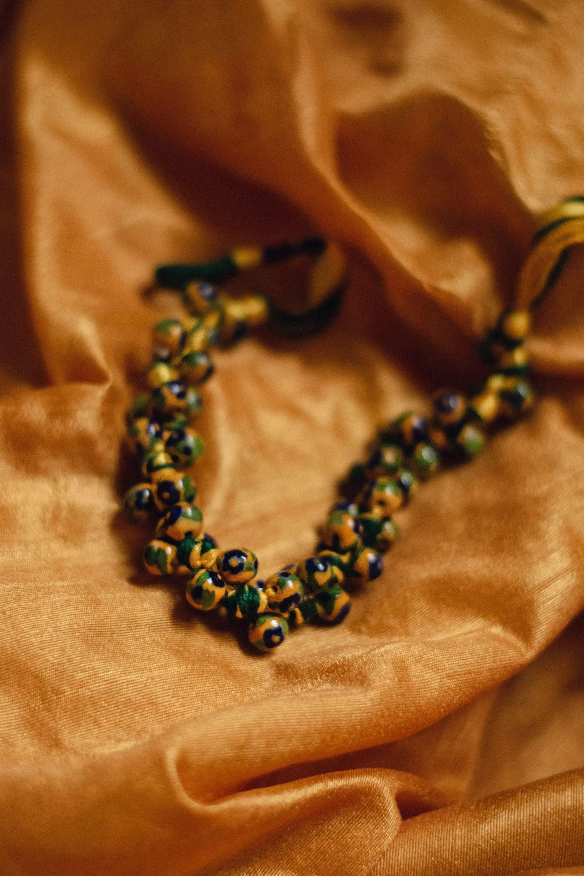 Kaisori Blue Pottery Knot necklace - yellow and green